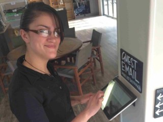 =\"Image of a guest checking her emails on the new Orakei Korako visitor tablets