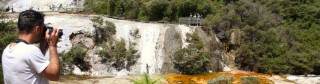 A visitor taking photos at Orakei Korako